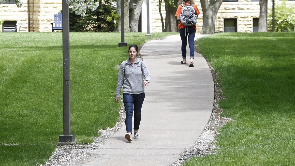 Students walk alone through campus