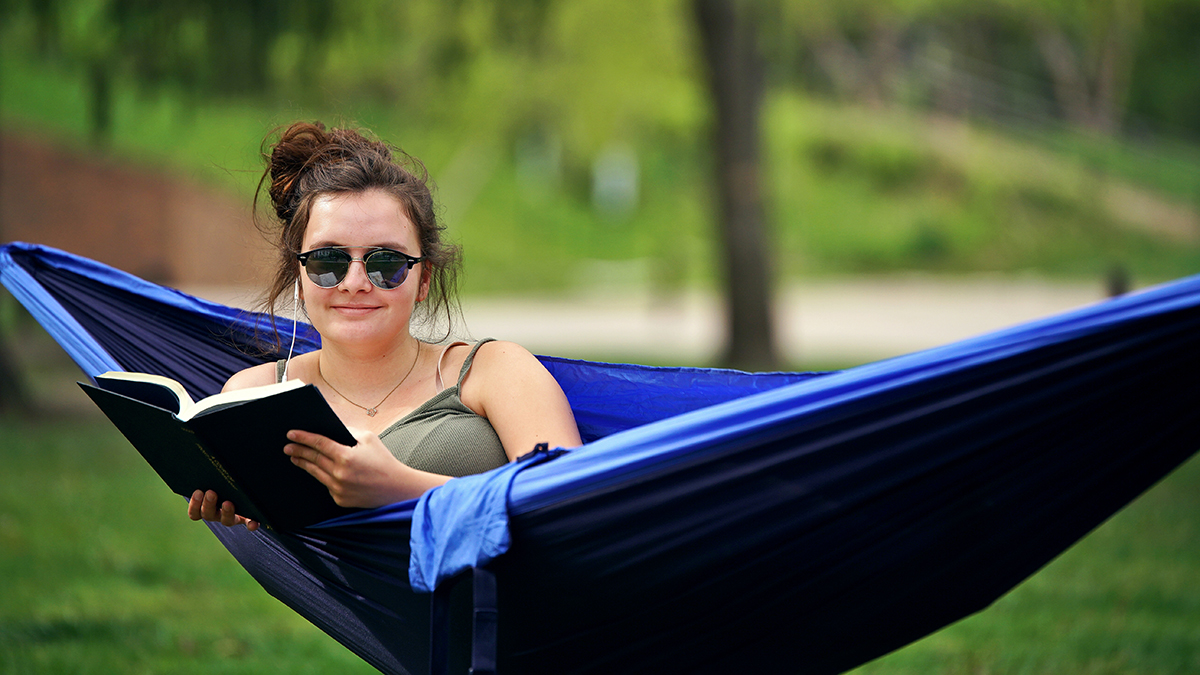 student enjoying summer in a hammock