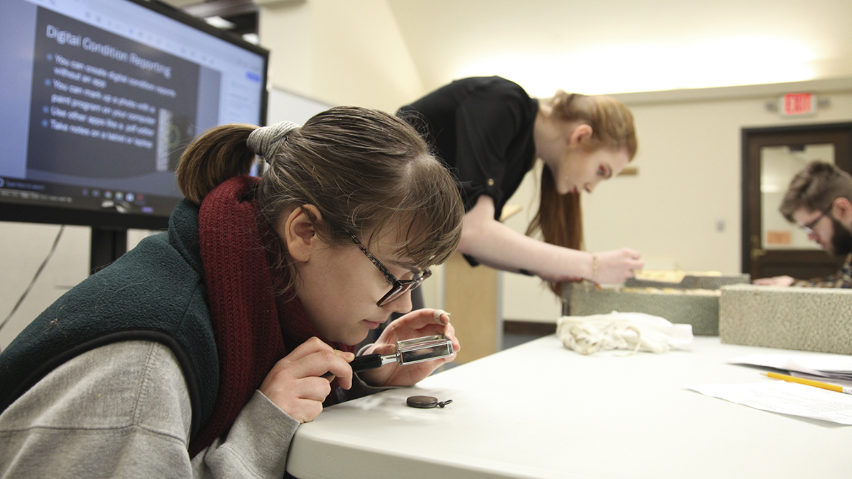 Students study artifacts during J-term course