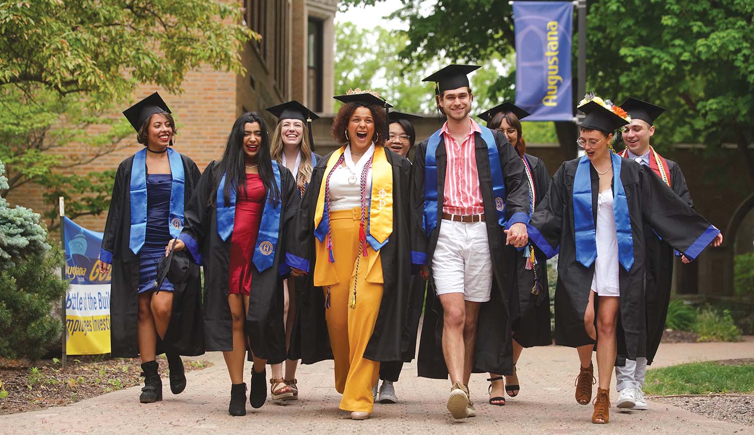 Graduates walking near Founders Hall
