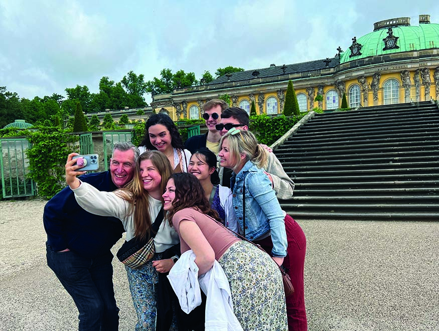 Augustana Choir Director Dr. Jon Hurty and students outside Sanssouci Palace in Potsdam, Germany