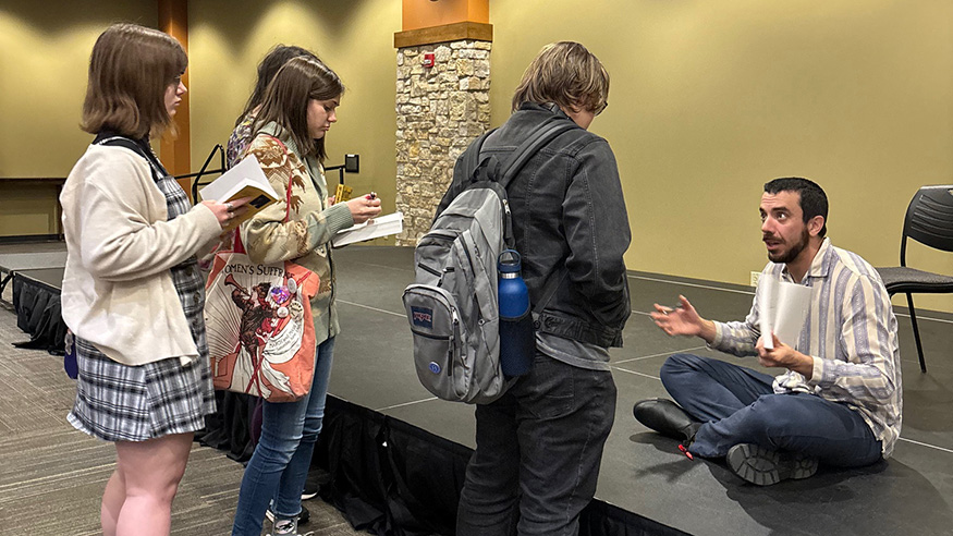 Kaveh Akbar speaking with students