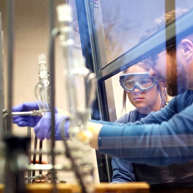 Student and professor in chemistry class