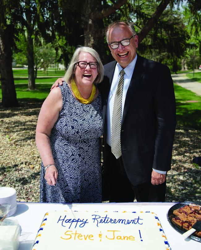 Steve and Jane Bahls prepare to cut the cake at their retirement ceremony