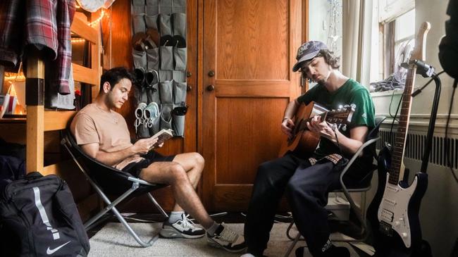 two male students in a dorm room