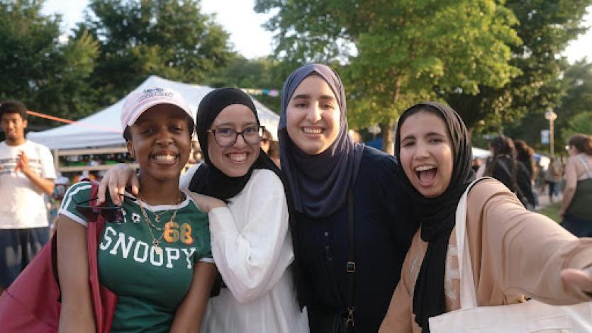 Four students smiling outside