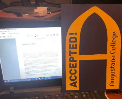 Gold 'A' with computer screen showing acceptance letter