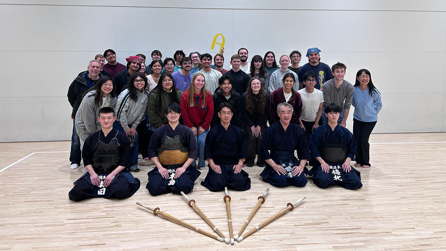 A group of students and instructors posing in a classroom Japan