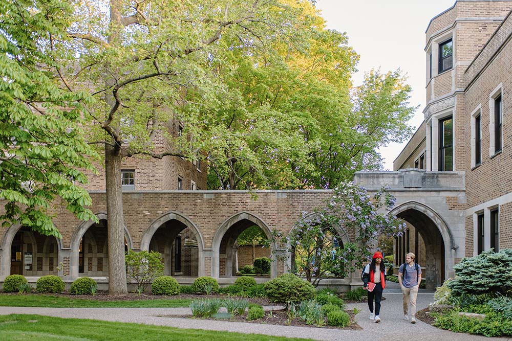 Students walking through the arches from Founders Courtyard.