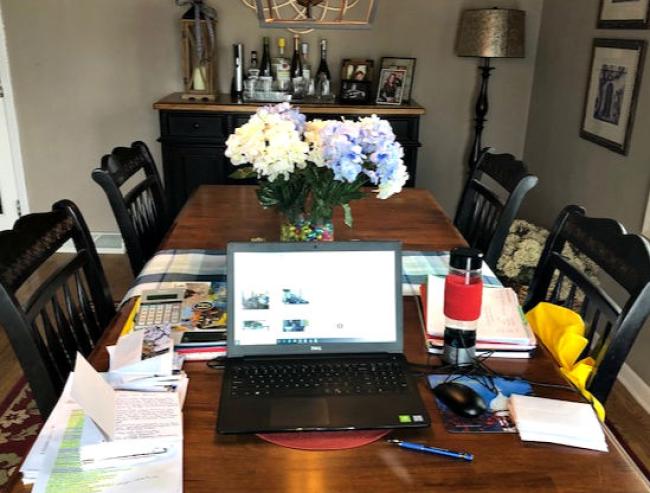 Kitchen table with flowers and laptop
