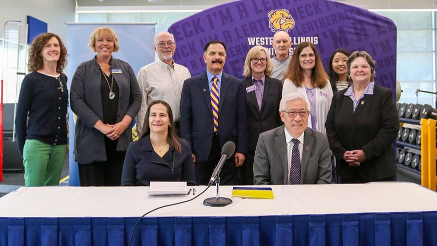 Augustana College and WIU representatives at the signing event.