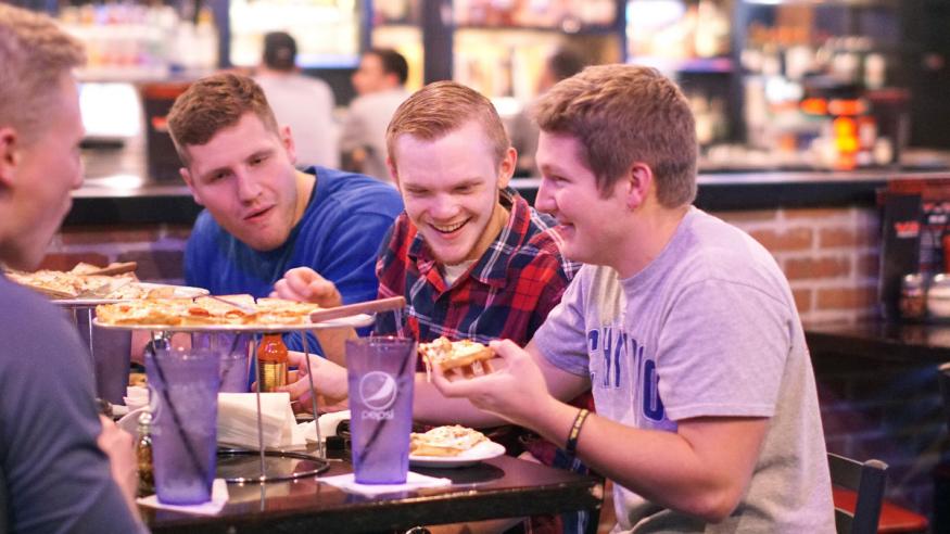 students enjoying QC style pizza